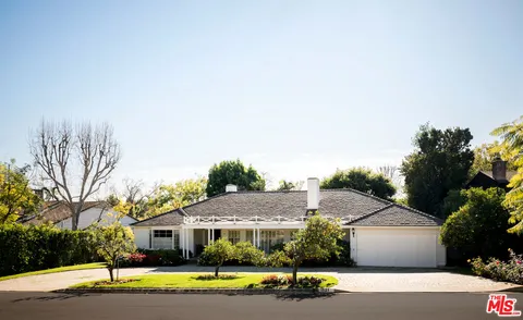 a view of house with outdoor space and swimming pool
