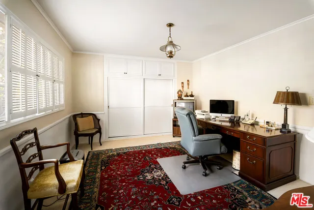 a bedroom with a bed and glass window