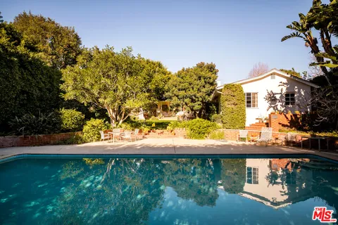 a view of a swimming pool with a yard