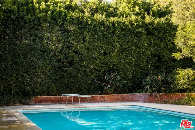an aerial view of house with yard swimming pool and outdoor seating