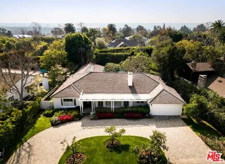 an aerial view of a houses with a swimming pool
