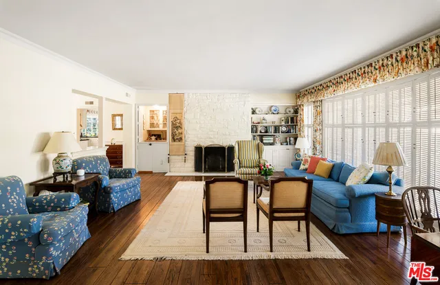 a living room with fireplace furniture and a wooden floor