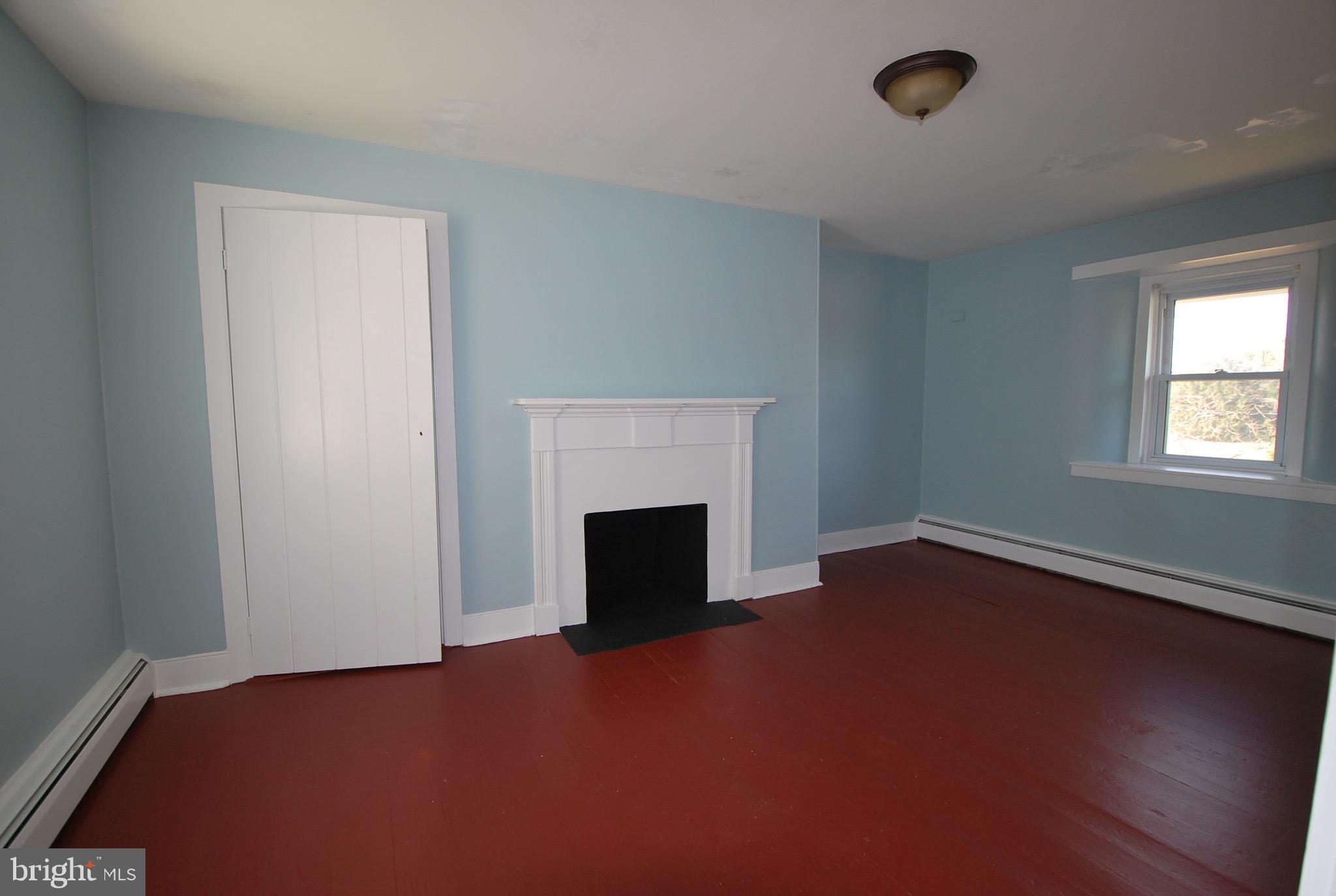 592 Blake Road Elkton, MD 21921 - Photo 11 of 18 an empty room with windows and fireplace