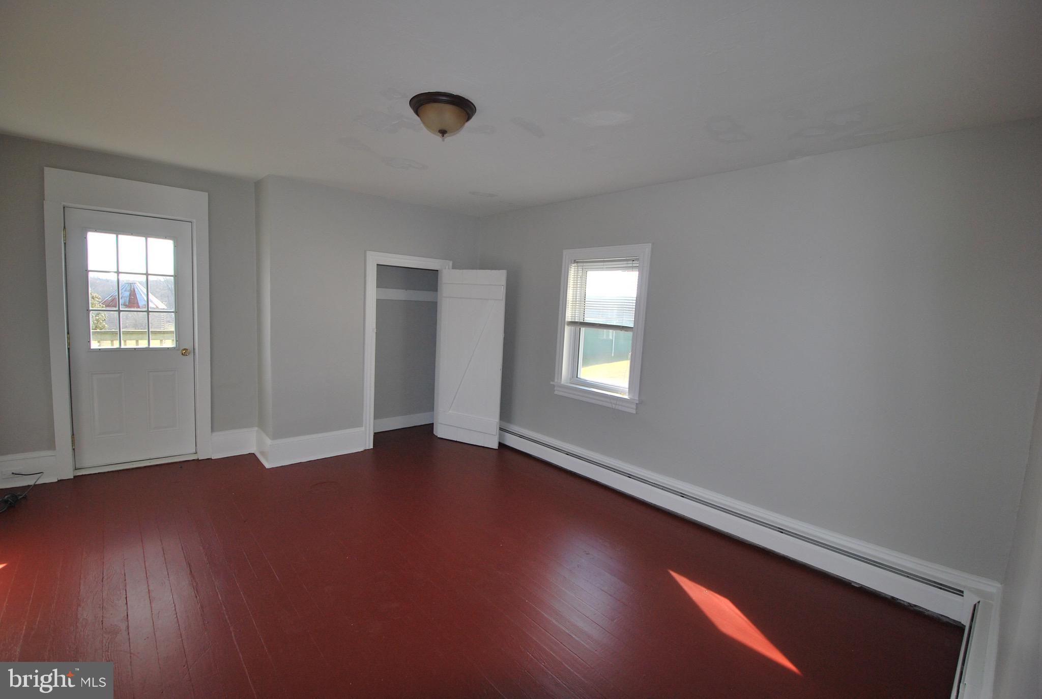 592 Blake Road Elkton, MD 21921 - Photo 10 of 18 an empty room with wooden floor and windows