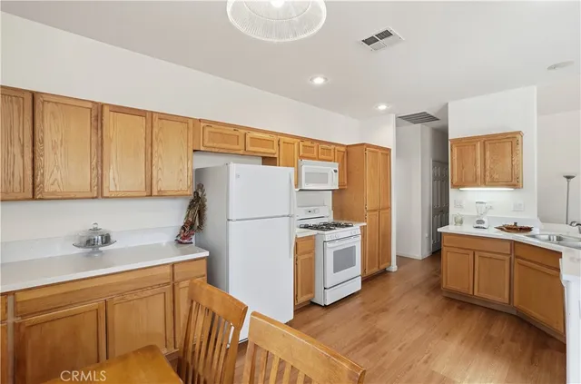 a kitchen with white cabinets and white appliances