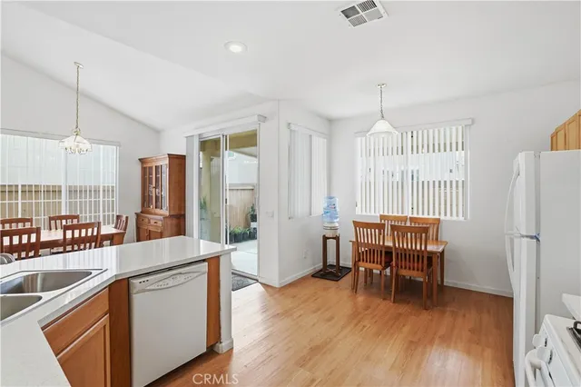 a large kitchen with a table and chairs
