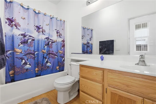a bathroom with a sink a toilet and a shower curtain