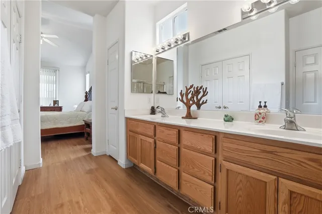 a spacious bathroom with a double vanity sink and mirror