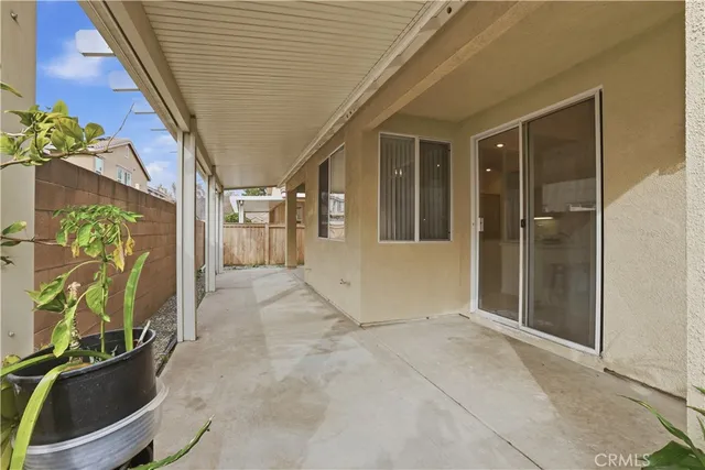 a view of a porch with a table and chairs and potted plants