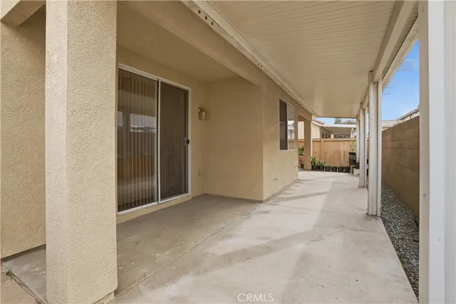 a view of a hallway with wooden shelves