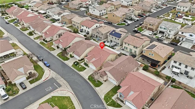 an aerial view of a house with a yard