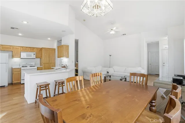 a large kitchen with a table and chairs