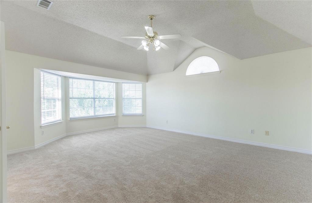 4136 Los Altos Drive Plano, TX 75024 - Photo 11 of 31 an empty room with chandelier fan and windows