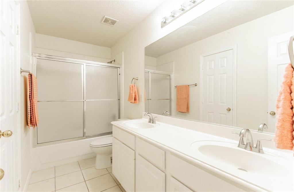 4136 Los Altos Drive Plano, TX 75024 - Photo 13 of 31 a bathroom with a sink toilet and shower