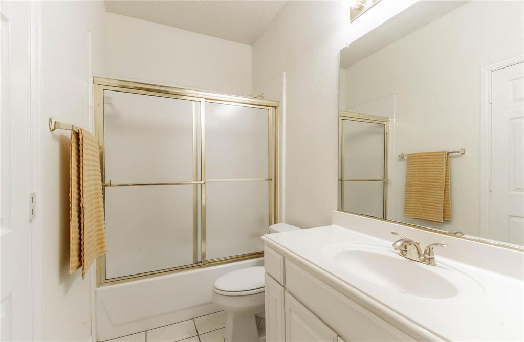 4136 Los Altos Drive Plano, TX 75024 - Photo 17 of 31 a bathroom with a granite countertop sink toilet and shower