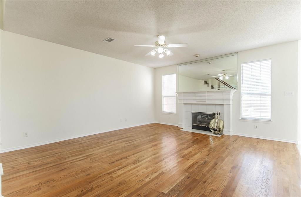 4136 Los Altos Drive Plano, TX 75024 - Photo 19 of 31 wooden floor in an empty room with a fireplace