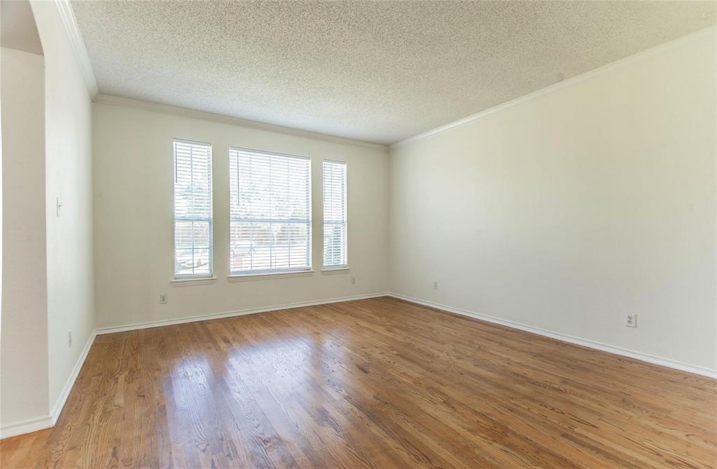 4136 Los Altos Drive Plano, TX 75024 - Photo 26 of 31 an empty room with wooden floor and windows