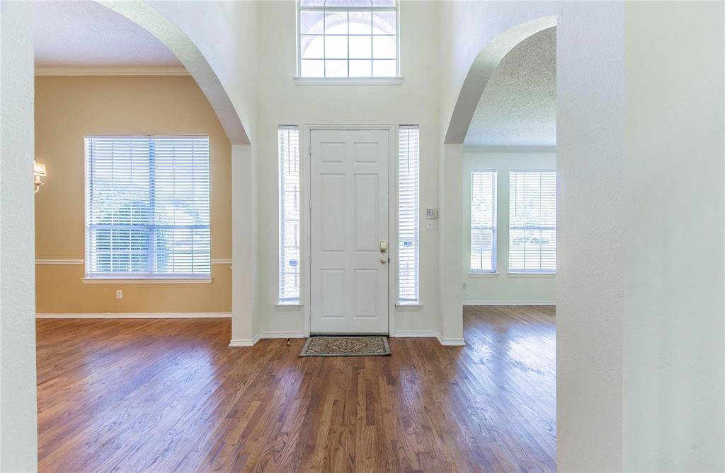 4136 Los Altos Drive Plano, TX 75024 - Photo 27 of 31 an empty room with wooden floor and windows