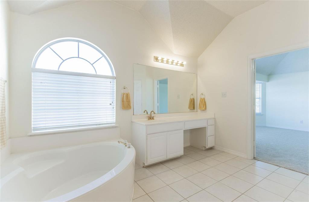 4136 Los Altos Drive Plano, TX 75024 - Photo 28 of 31 a spacious bathroom with a tub a sink and a mirror