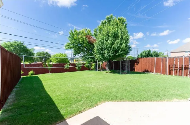 a view of a backyard with a garden and entertaining space