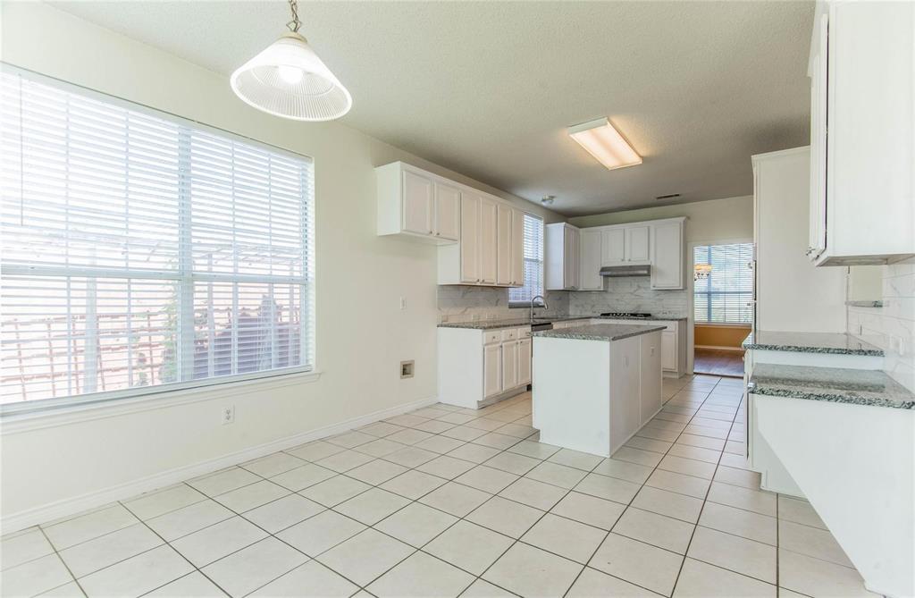 4136 Los Altos Drive Plano, TX 75024 - Photo 8 of 31 a kitchen with cabinets and window