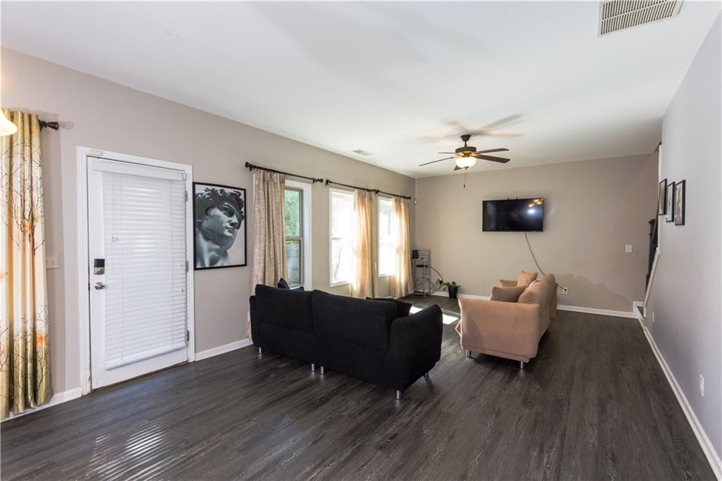 4245 Pear Haven Lane Gainesville, GA 30504 - Photo 16 of 39 a living room with furniture and a wooden floor