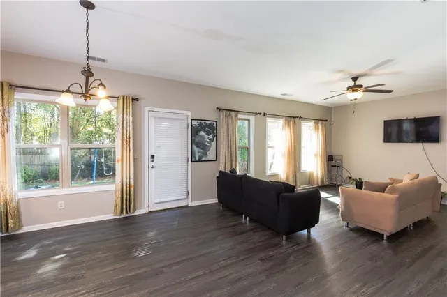 a living room with furniture and a chandelier