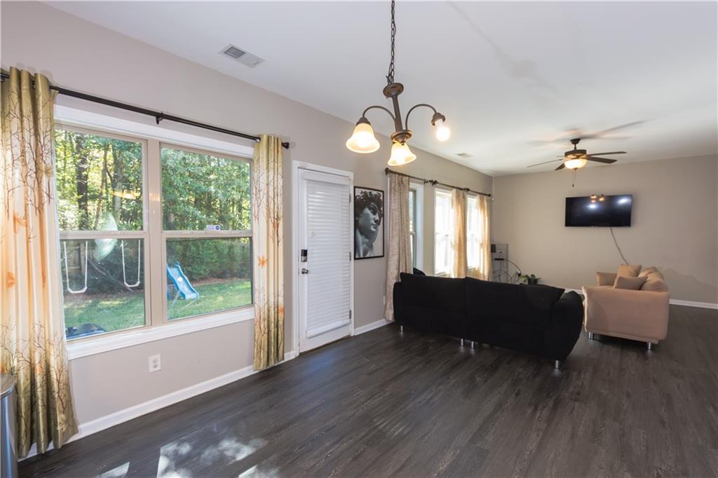 4245 Pear Haven Lane Gainesville, GA 30504 - Photo 18 of 39 a living room with furniture chandelier and a large window