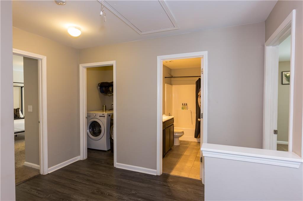 4245 Pear Haven Lane Gainesville, GA 30504 - Photo 22 of 39 a view of a hallway with wooden floor a sink and a bathroom