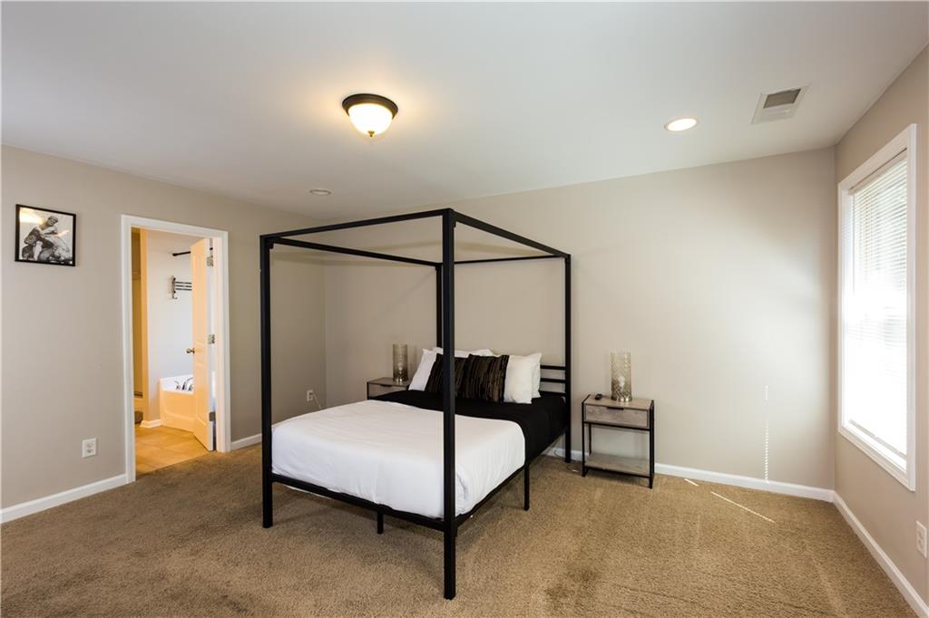 4245 Pear Haven Lane Gainesville, GA 30504 - Photo 23 of 39 a bedroom with a bed a table and painting