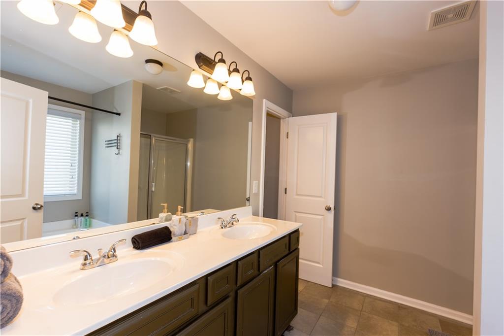 4245 Pear Haven Lane Gainesville, GA 30504 - Photo 25 of 39 a bathroom with a sink and a mirror