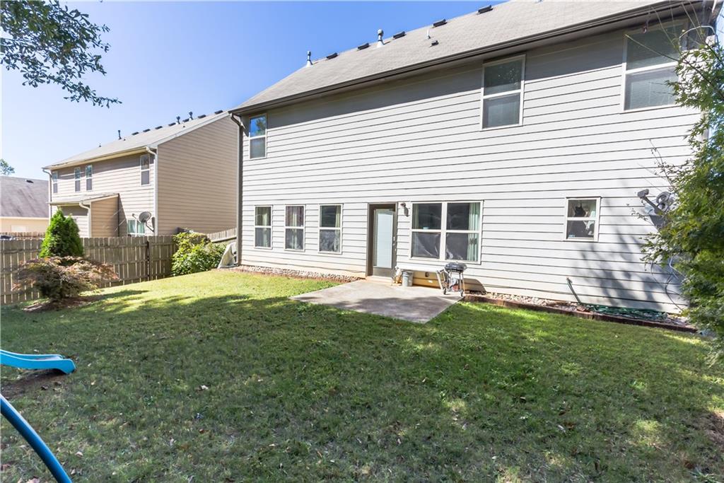 4245 Pear Haven Lane Gainesville, GA 30504 - Photo 3 of 39 a backyard of a house with table and chairs and potted plants