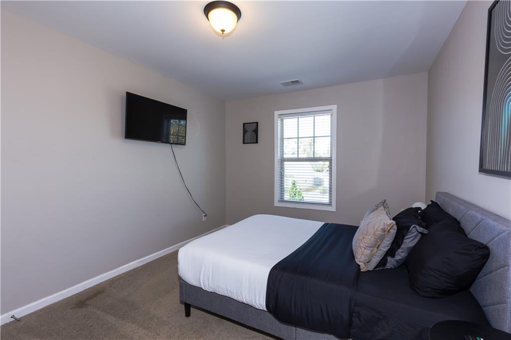 4245 Pear Haven Lane Gainesville, GA 30504 - Photo 31 of 39 a bedroom with a bed and a flat screen tv