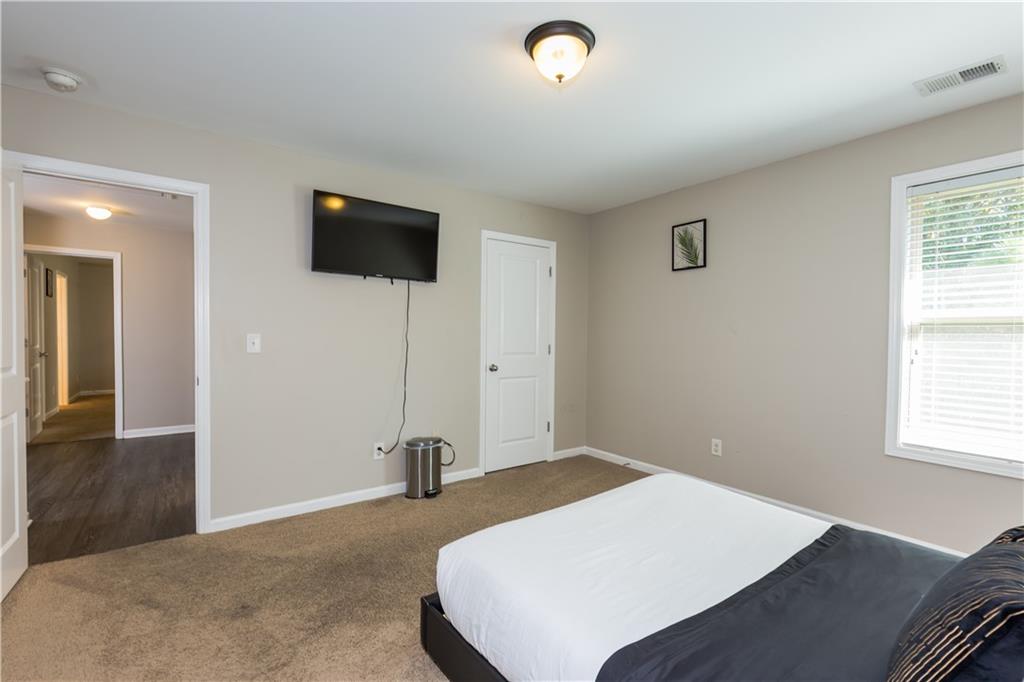 4245 Pear Haven Lane Gainesville, GA 30504 - Photo 35 of 39 a bedroom with a bed and a flat screen tv