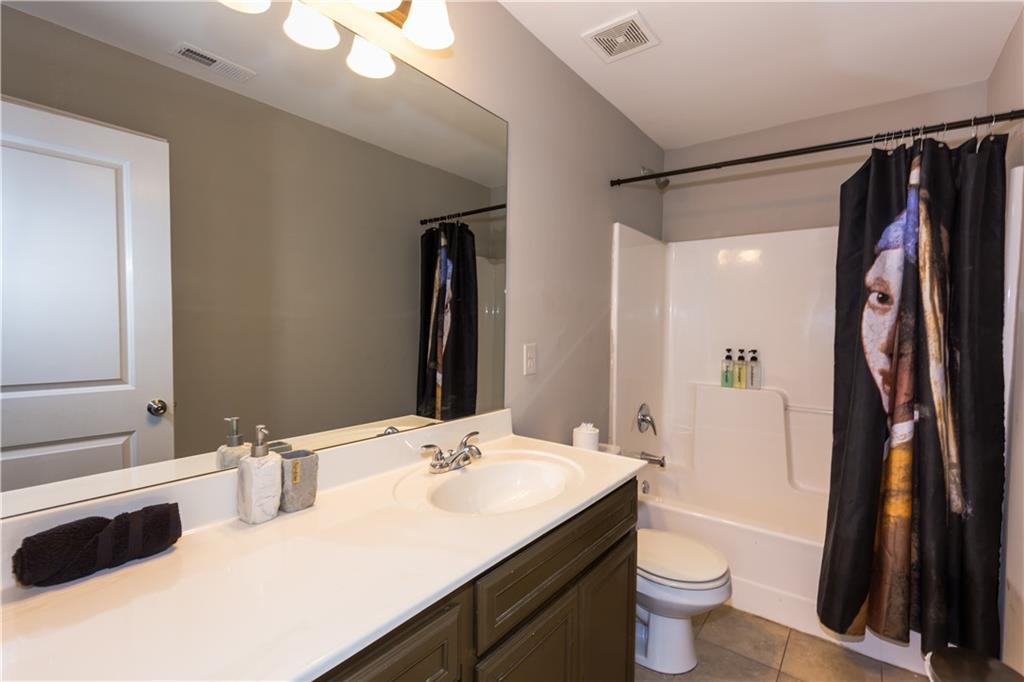 4245 Pear Haven Lane Gainesville, GA 30504 - Photo 38 of 39 a bathroom with a sink a toilet a tub and shower