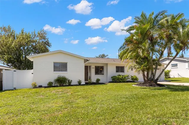 a view of a house with backyard and garden