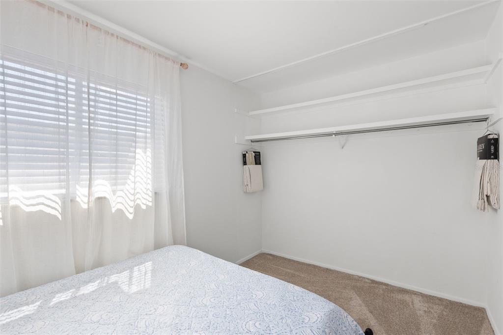 3488 Shady Bluff Drive Largo, FL 33770 - Photo 19 of 29 a bedroom with a bed and a window