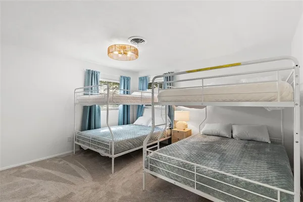 a bedroom with a bed and a table