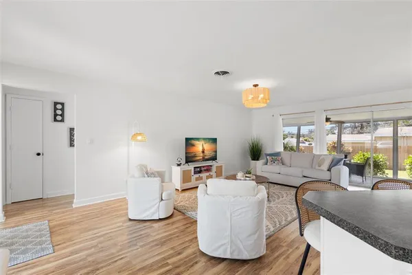 a living room with fireplace furniture and a wooden floor