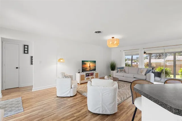 a living room with fireplace furniture and a wooden floor