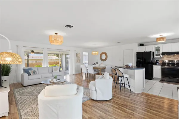 a living room with furniture and a wooden floor