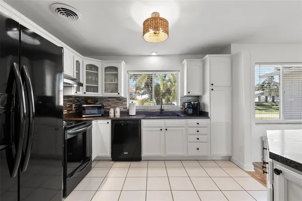 a kitchen with stainless steel appliances granite countertop a stove sink and cabinets