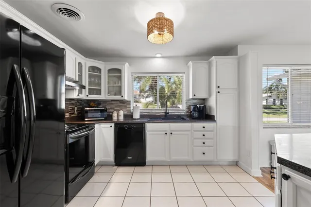 a kitchen with stainless steel appliances granite countertop a stove sink and cabinets