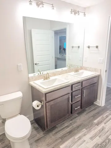 a bathroom with a sink toilet and mirror