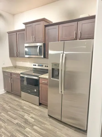 a kitchen with a refrigerator stove and microwave