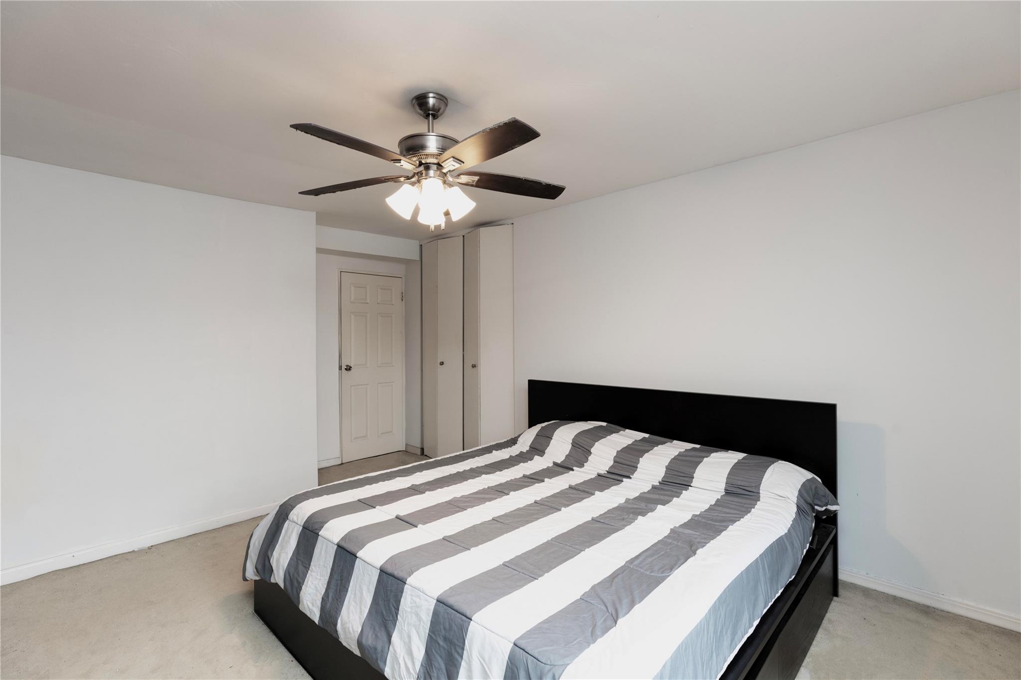 58-03 Calloway Street, Unit 3NN Queens, NY 11368 - Photo 17 of 23 a bedroom with a bed and a chandelier