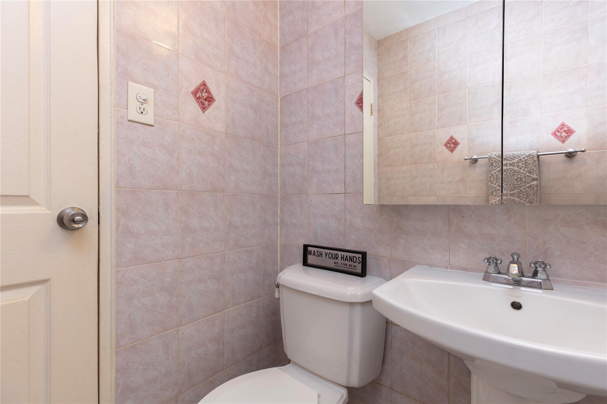 58-03 Calloway Street, Unit 3NN Queens, NY 11368 - Photo 19 of 23 a bathroom with a sink a toilet and shower curtain
