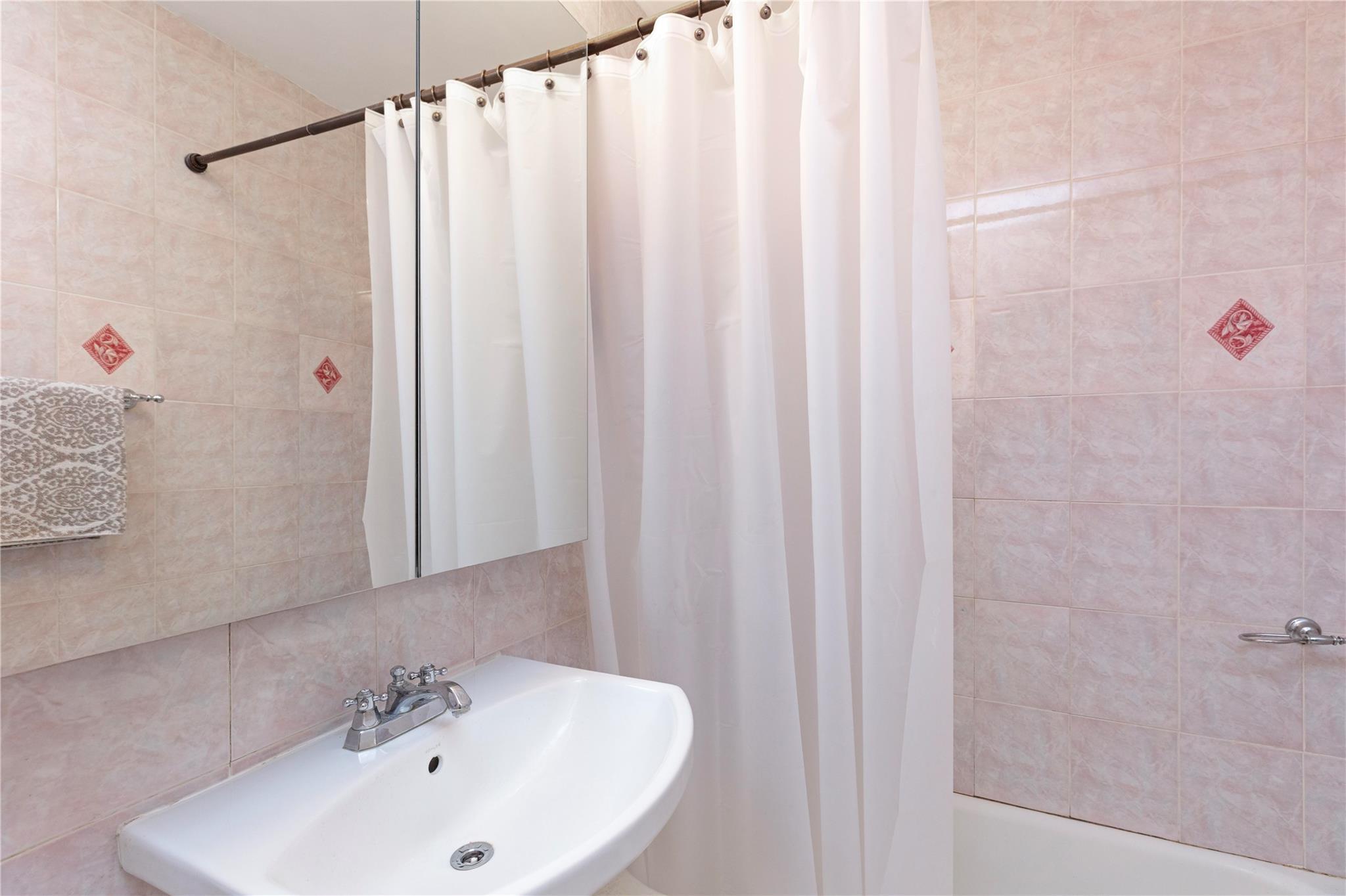 58-03 Calloway Street, Unit 3NN Queens, NY 11368 - Photo 21 of 23 a bathroom with a sink and a mirror