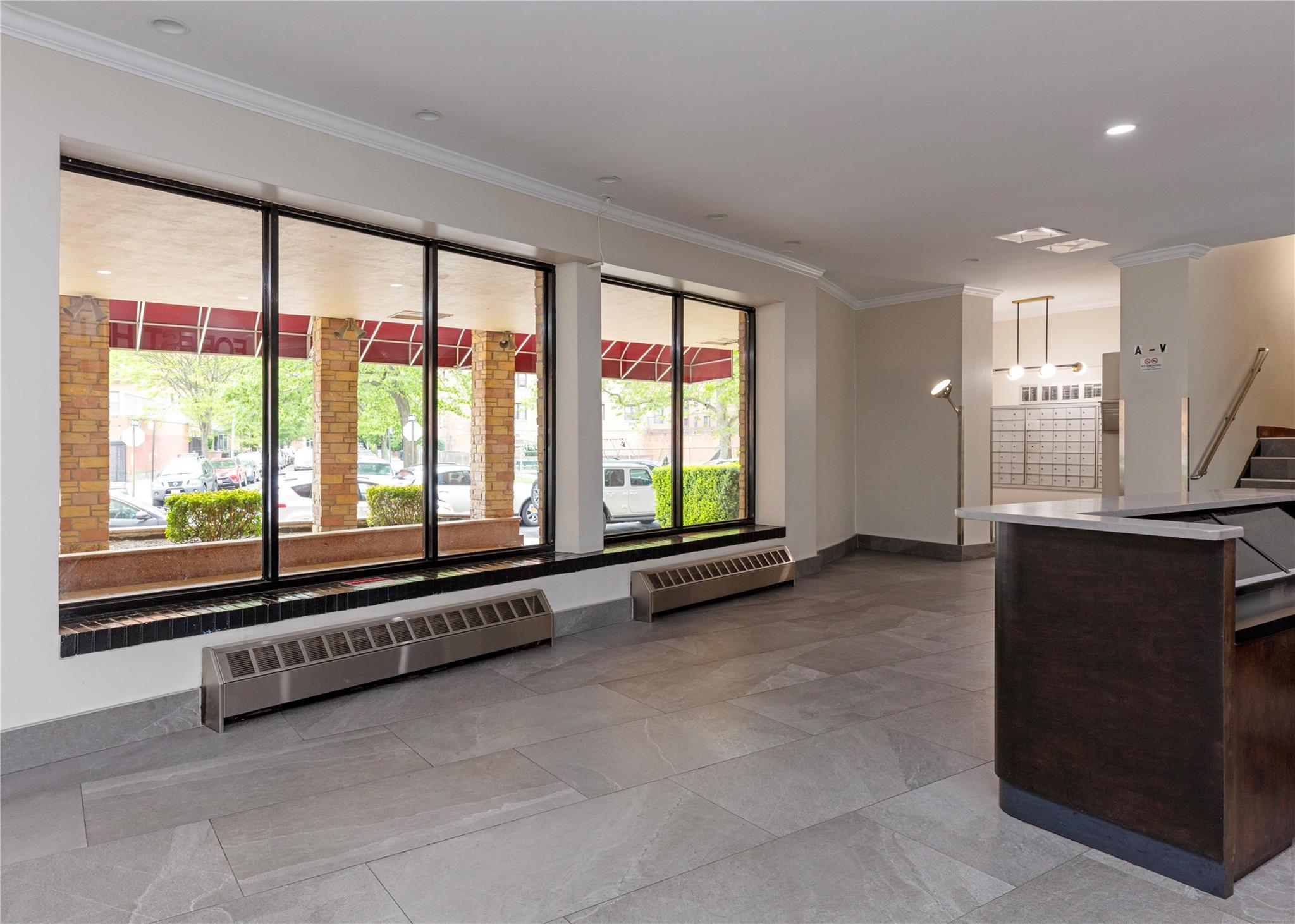 58-03 Calloway Street, Unit 3NN Queens, NY 11368 - Photo 3 of 23 a view of an empty room with a fireplace and large windows