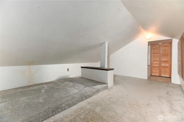 a bathroom with a granite countertop sink mirror vanity and toilet